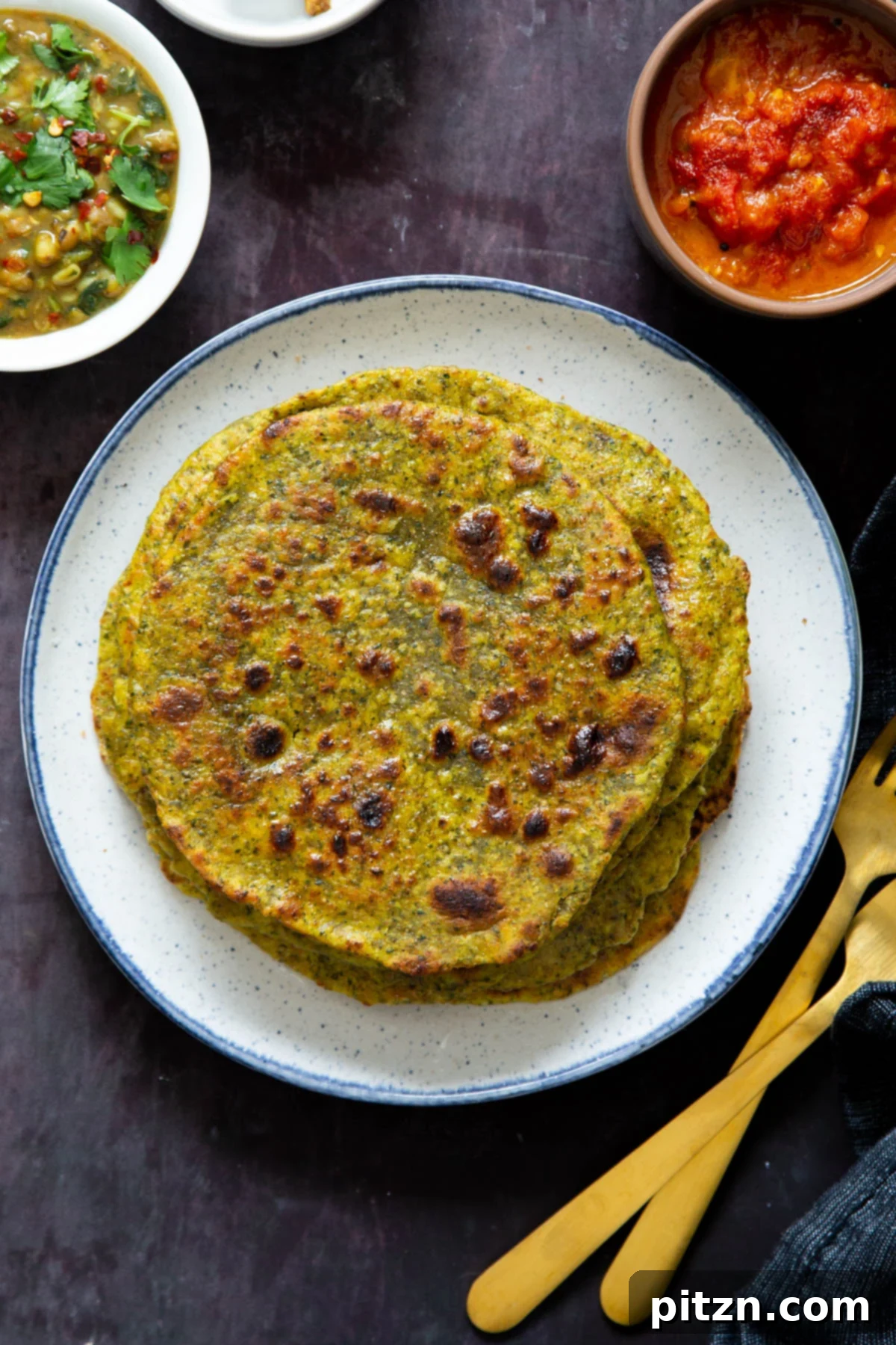 Aromatic Masala Paratha: Easy Yeast-Free Indian Flatbread 15 three masala parathas with small dishes of chutney and golden cutlery