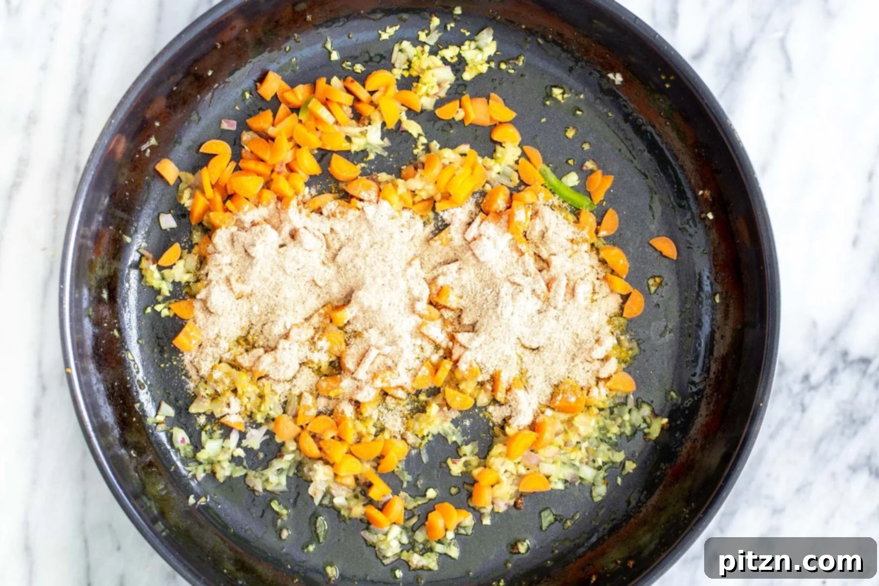 Vibrant Malaysian Tofu Curry 10 Chopped sautéed veggies in a black skillet