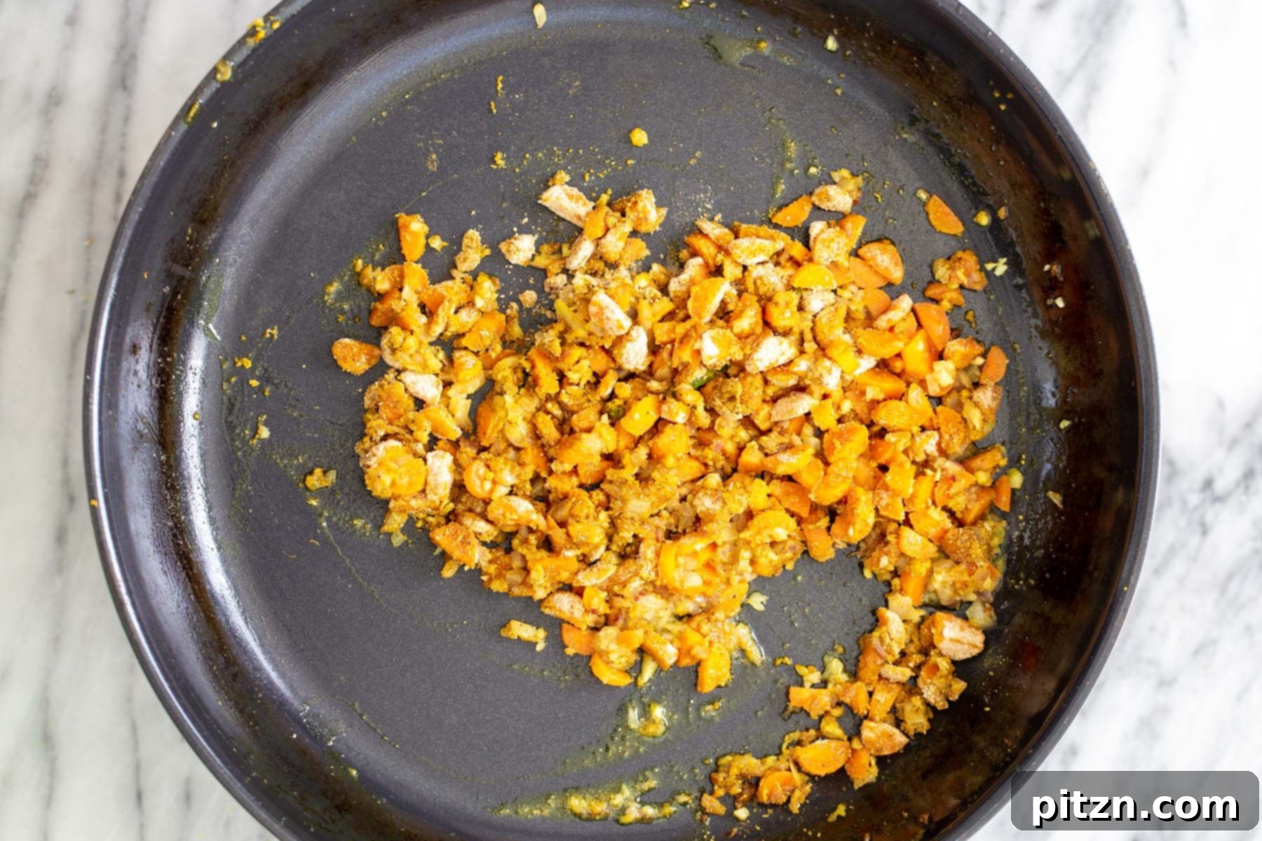 Vibrant Malaysian Tofu Curry 11 Chopped sautéed veggies and garlic in a skillet