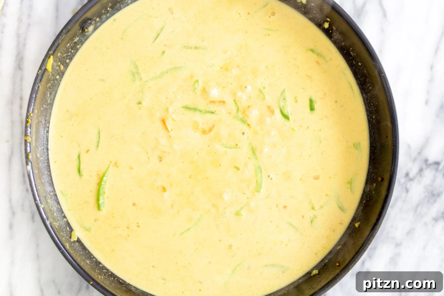 Vibrant Malaysian Tofu Curry 13 Coconut curry in a sautéing pan