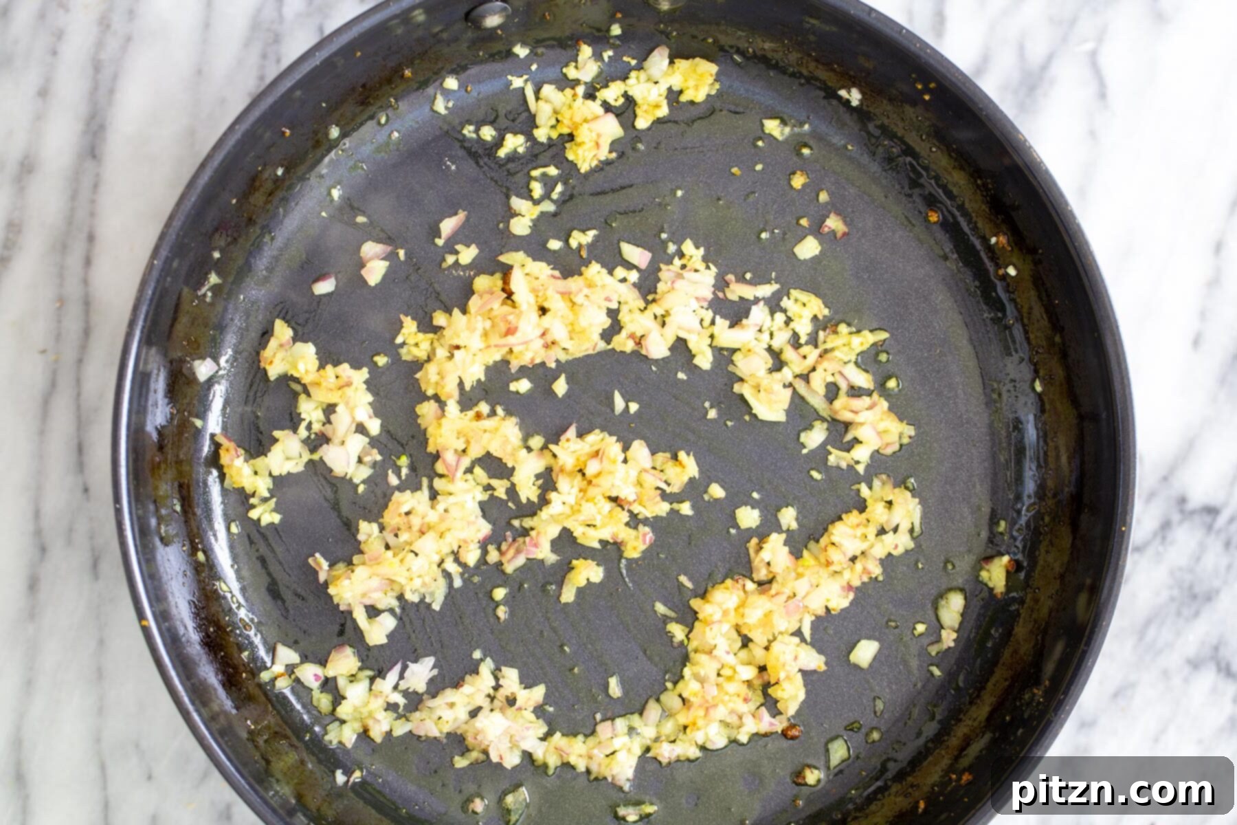 Vibrant Malaysian Tofu Curry 9 Ginger and onion sautéing in a black skillet