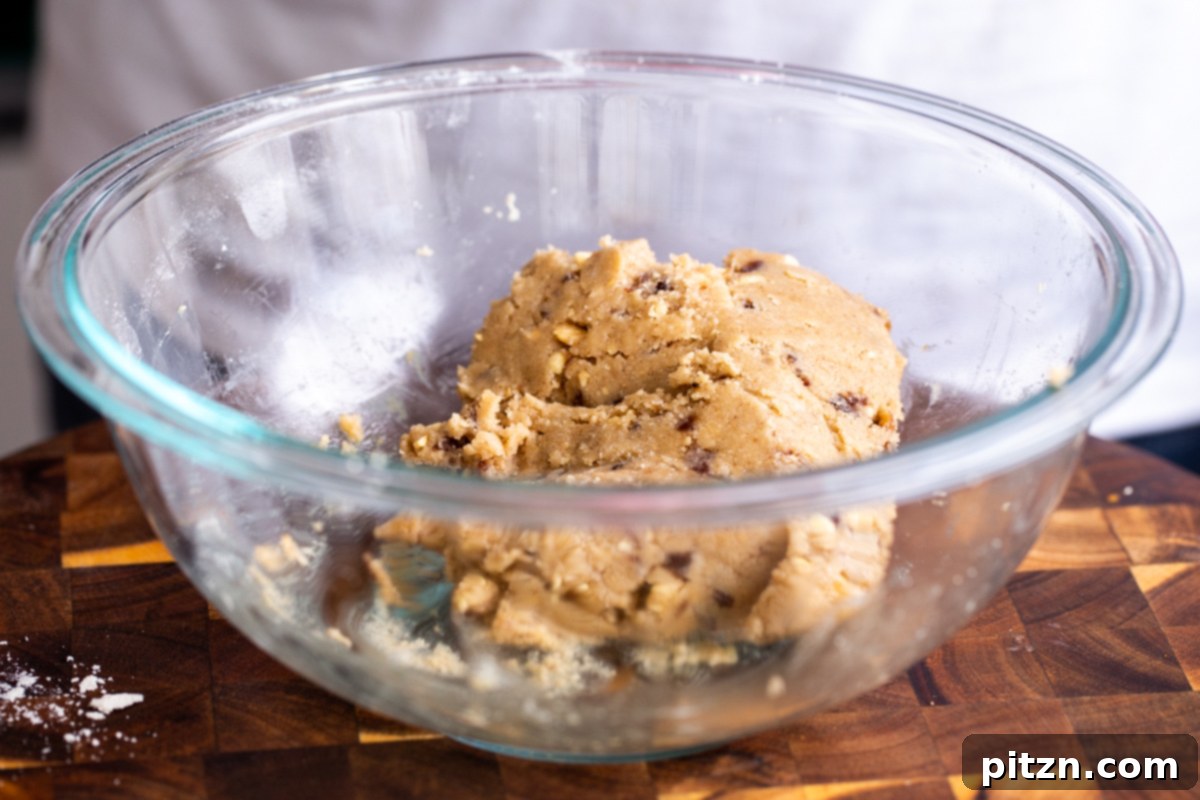 The Ultimate Vegan Gluten-Free Snickers Cookies 12 The vegan Snickers cookie dough, perfectly mixed and ready for shaping, resting in a glass bowl.