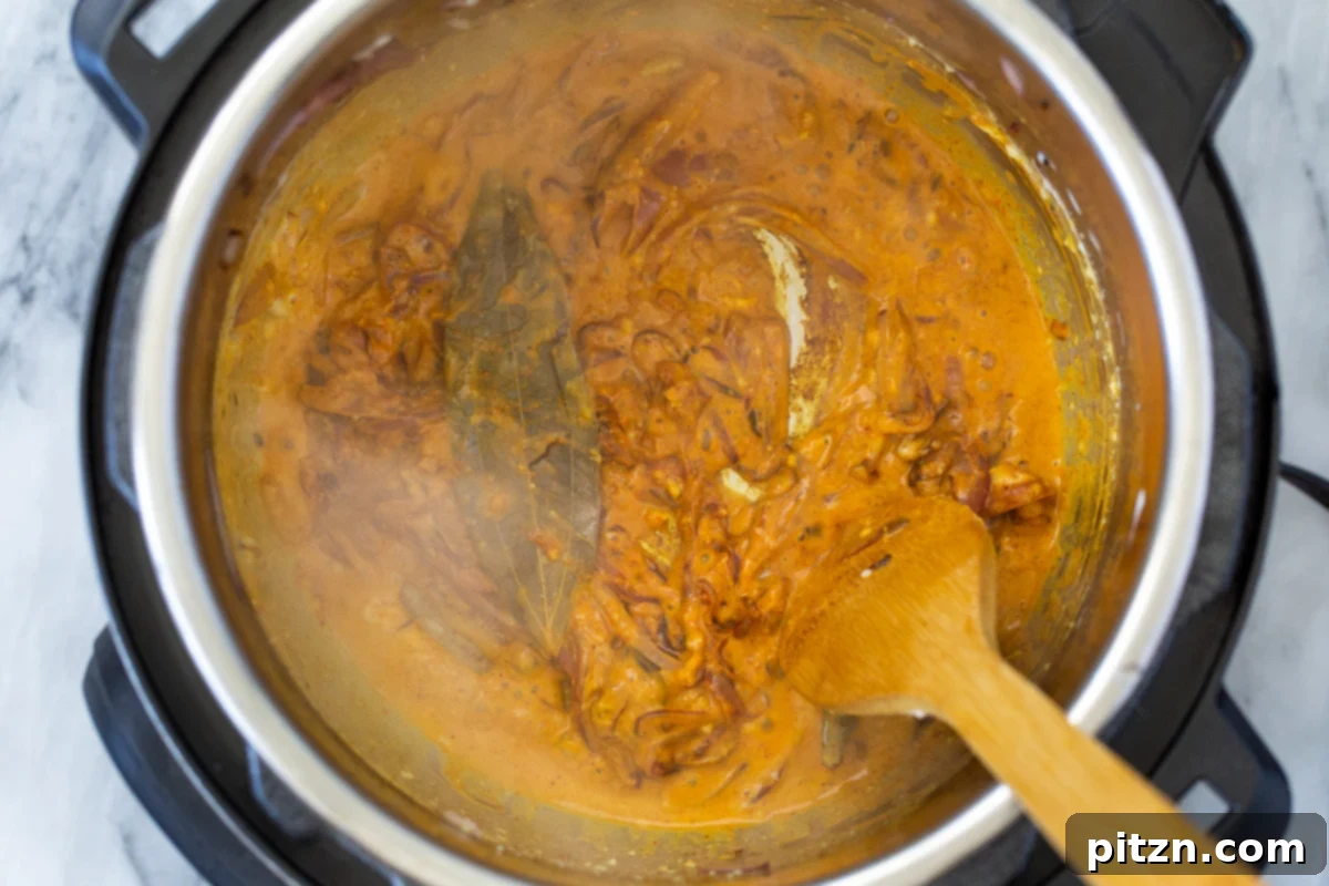 Fragrant Mushroom Biryani 14 A vibrant mix of spices, yogurt, and onions simmering in an Instant Pot, creating an aromatic curry base.
