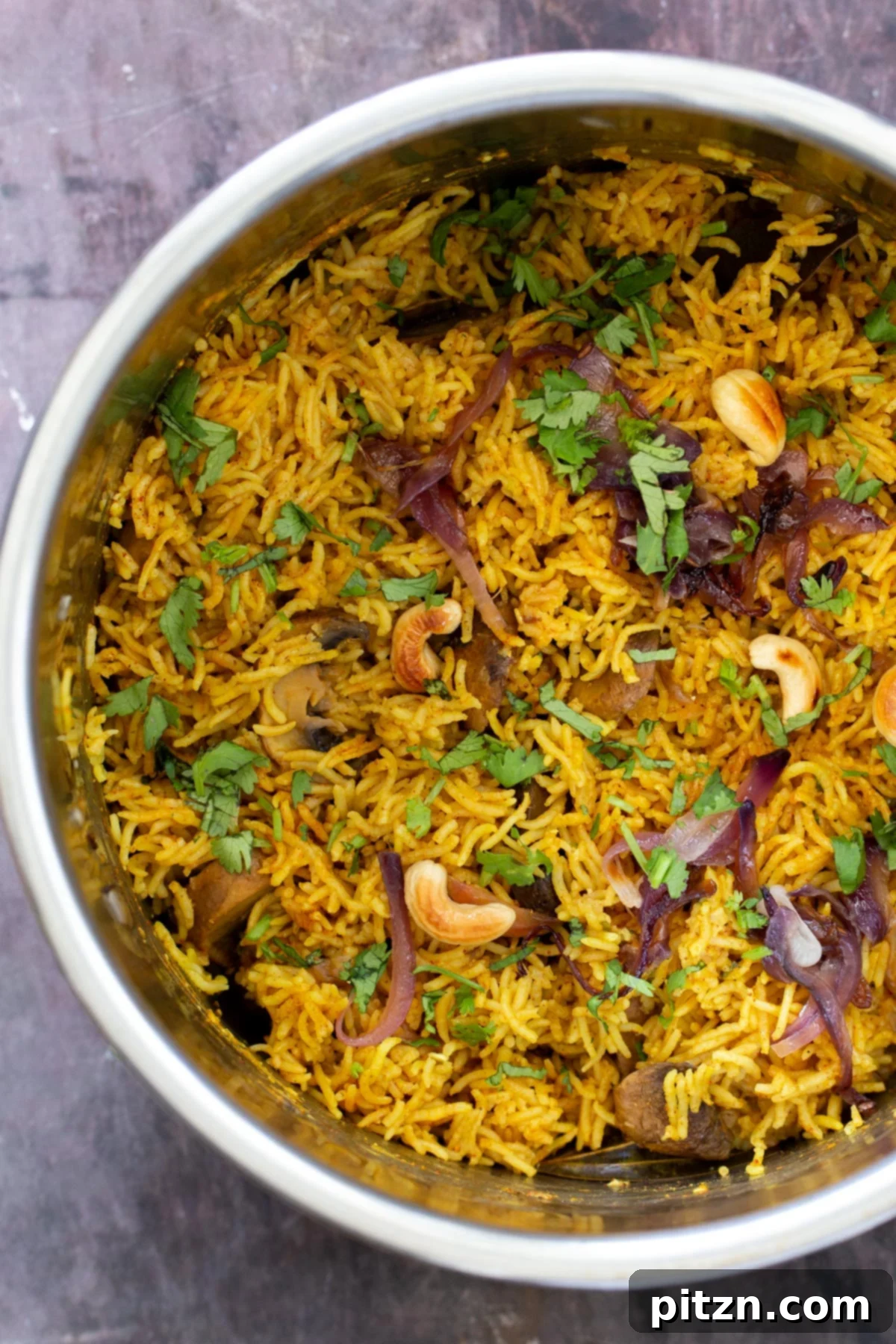 Fragrant Mushroom Biryani 3 Steaming vegan mushroom biryani, freshly cooked in an Instant Pot and sprinkled with cilantro, ready to be served.