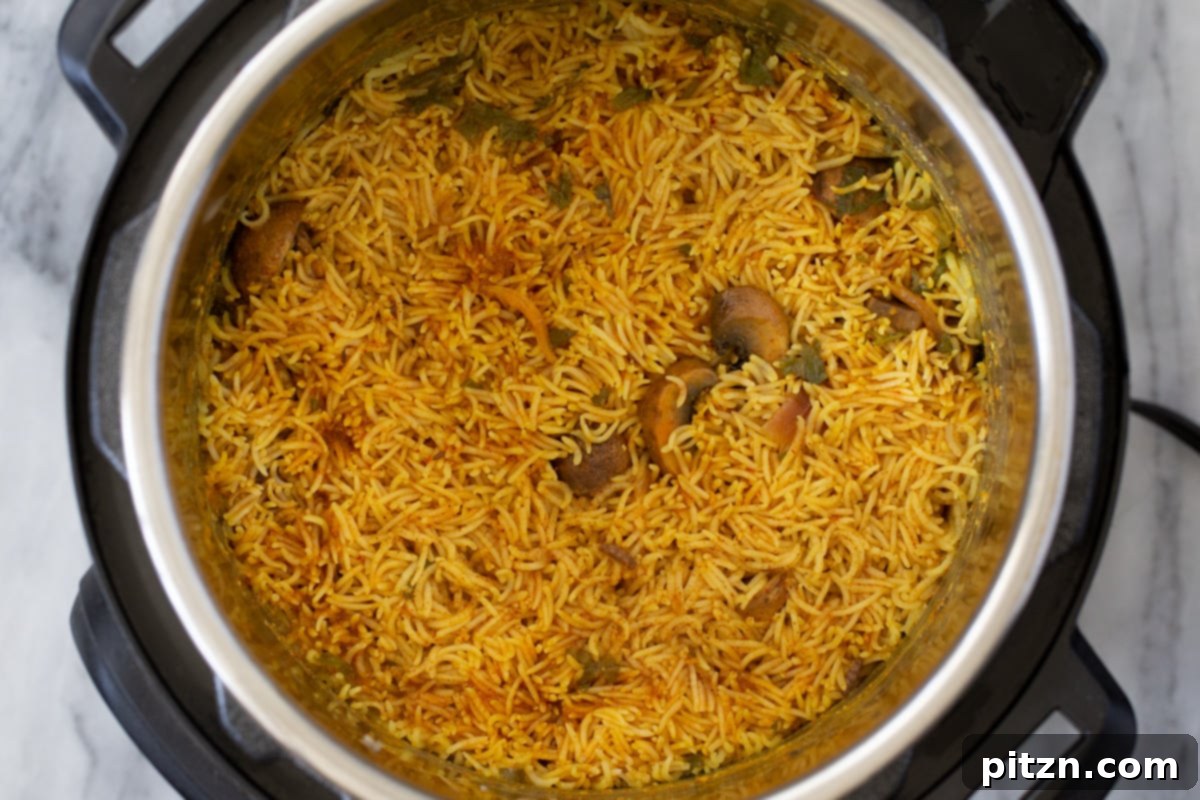 Fragrant Mushroom Biryani 21 Fluffy cooked rice and tender mushrooms, beautifully combined in an Instant Pot, forming a delicious biryani.