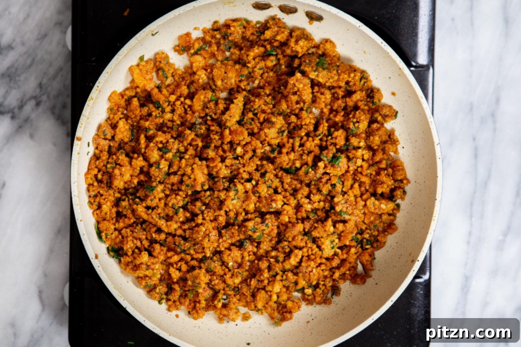 The fully cooked and seasoned lentil filling for vegan kachori pinwheels in a sauté pan, ready to be cooled.