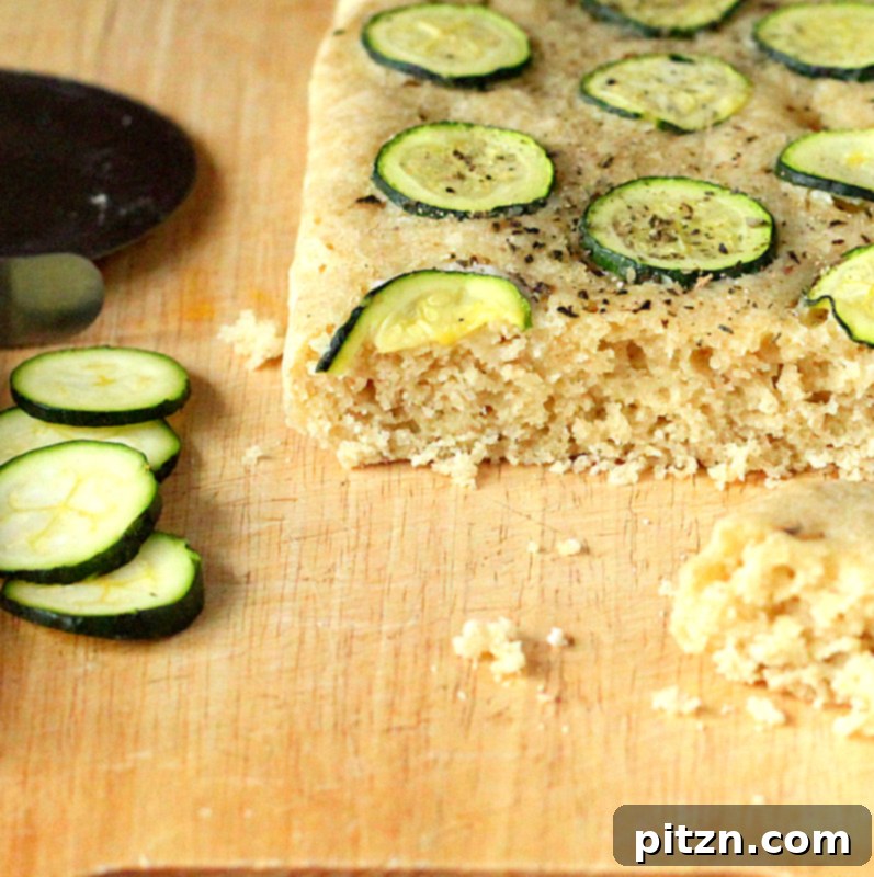 Naturally Gum-Free Vegan Gluten-Free Zucchini Basil Focaccia 7 A beautifully presented Gluten-free Zucchini Basil Focaccia, whole and golden brown, ready to be sliced and served.