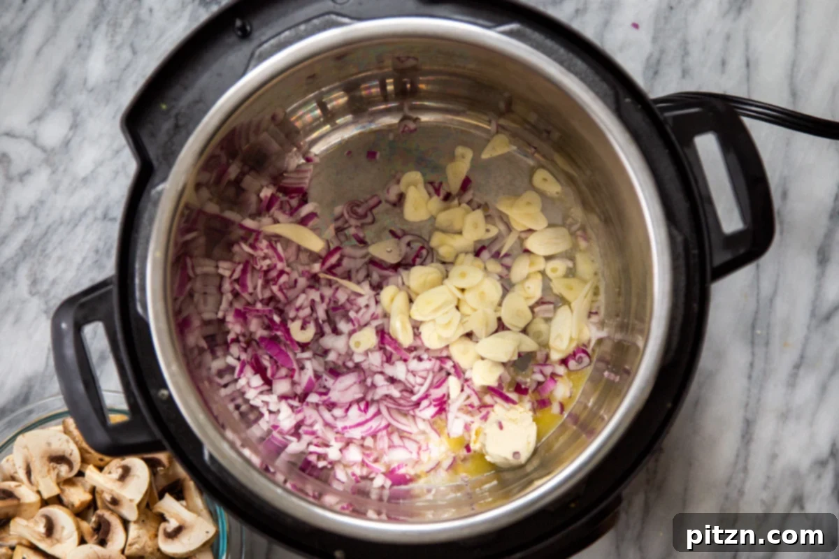 chopped red onion and sliced garlic in an Instant Pot 