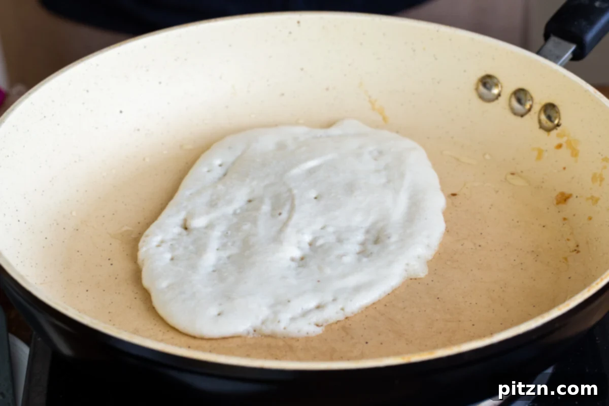 Spinach and Mushroom Stuffed Almond Flour Naan 12 Gluten-free almond flour naan batter being spread into a pan for cooking