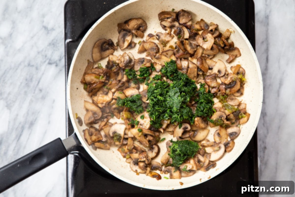 Spinach and Mushroom Stuffed Almond Flour Naan 16 Mushroom and spinach mixture cooking in a sautéing pan with spices