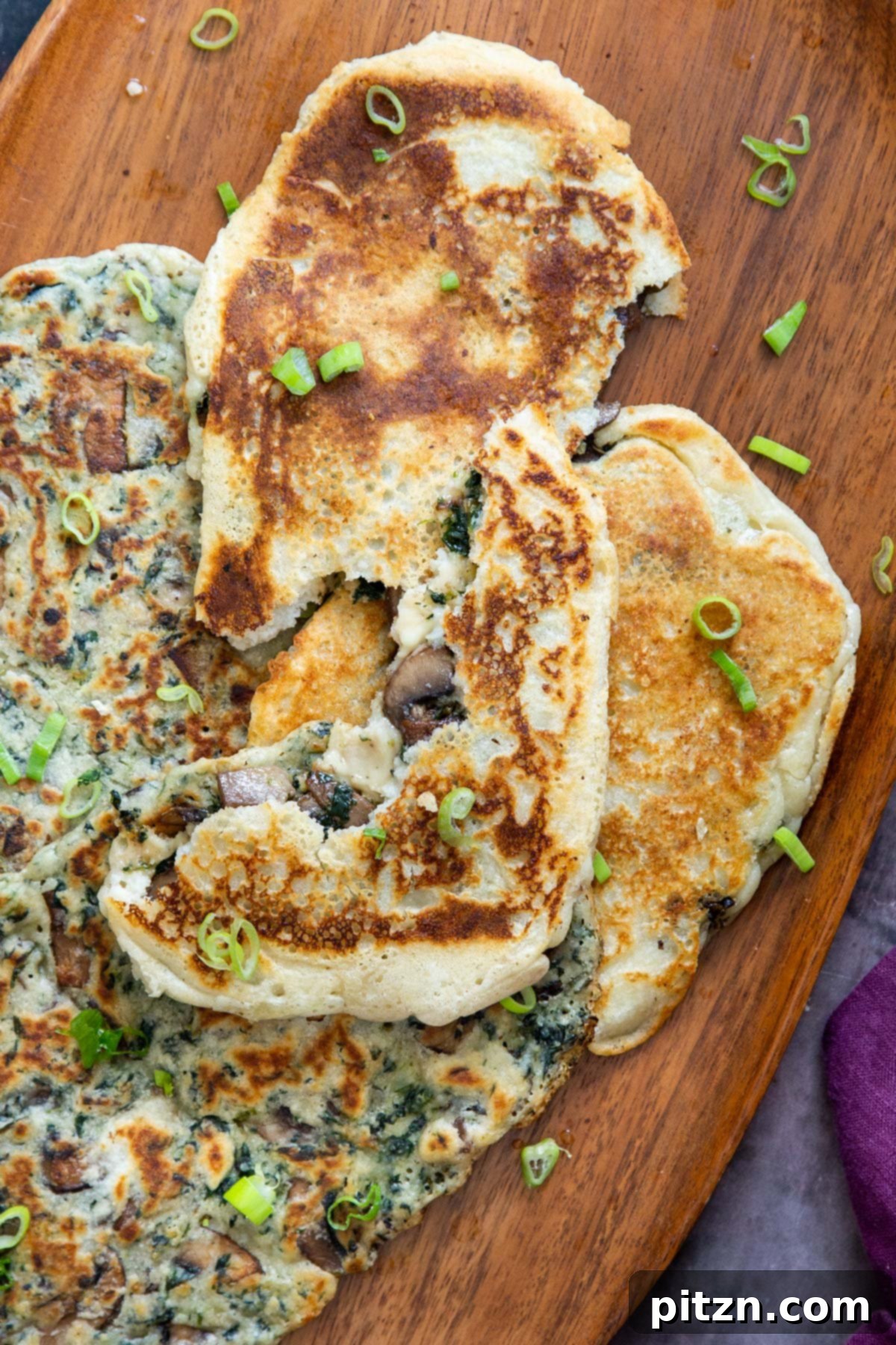 Spinach and Mushroom Stuffed Almond Flour Naan 25 Vegan gluten-free spinach and mushroom stuffed naan bread, sprinkled with sliced green onions, ready to be enjoyed
