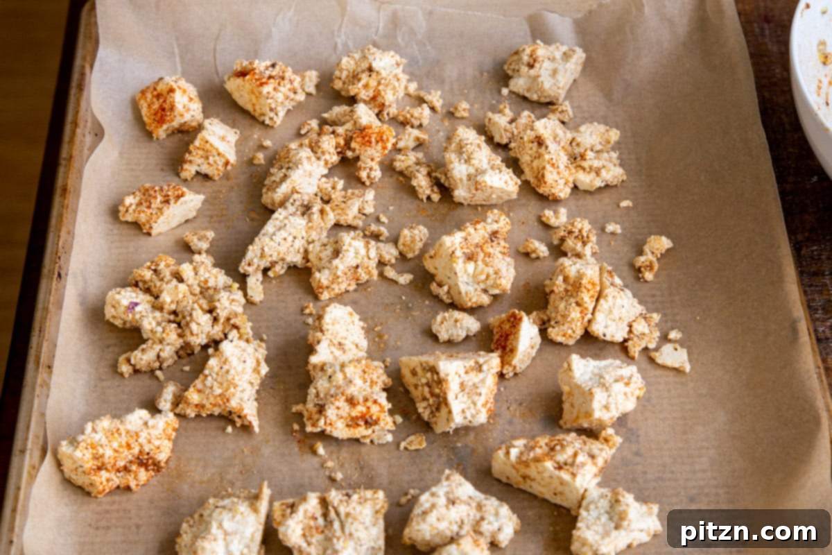 Plant-Based Chicken Changezi 9 Crispy, golden-brown marinated tofu chunks on a baking sheet after baking, ready to be added to the sauce.