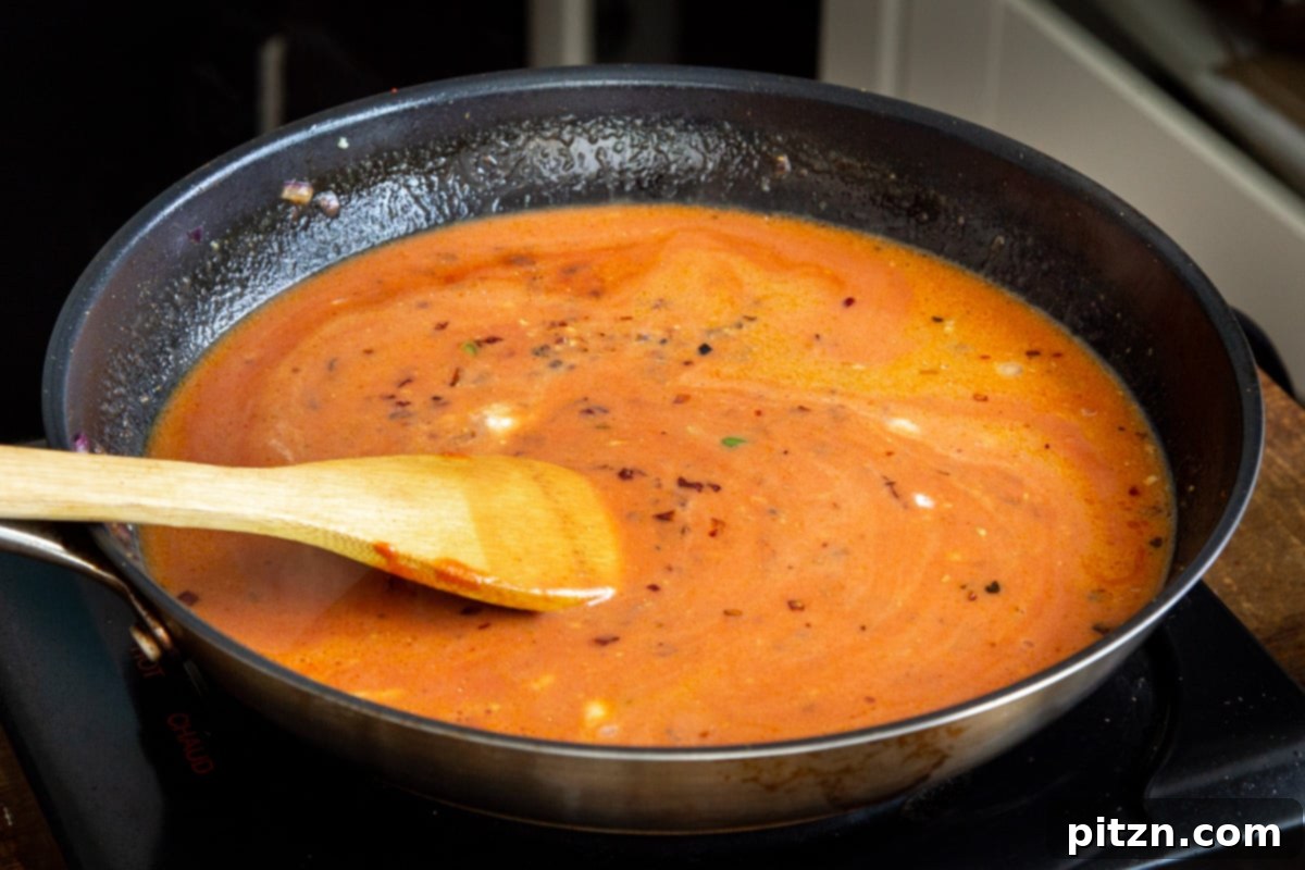 Plant-Based Chicken Changezi 15 Rich, creamy vegan chicken changezi gravy simmering in a black sautéing pan, infused with spices.