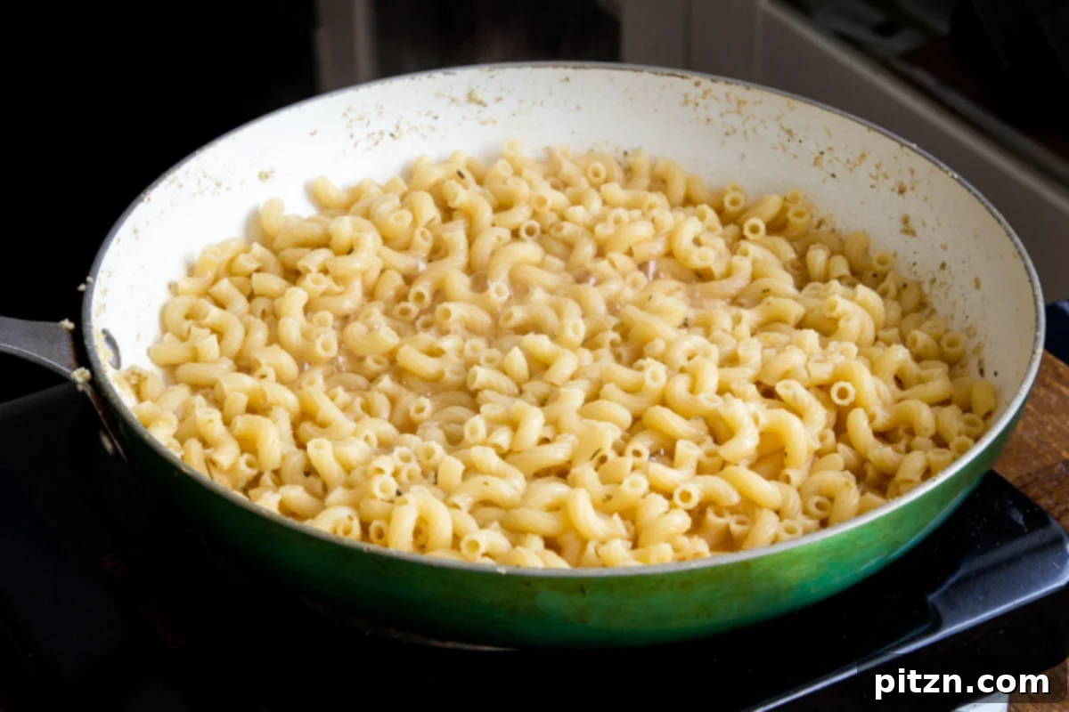 Fiery Vegan Skillet Mac and Cheese 10 Perfectly cooked pasta resting in a skillet, having absorbed the flavorful broth and ready for the next steps of sauce creation.