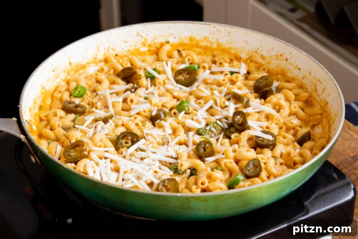Fiery Vegan Skillet Mac and Cheese 14 The final presentation of a comforting vegan jalapeño mac and cheese in a skillet, perfectly saucy and garnished, ready for serving.