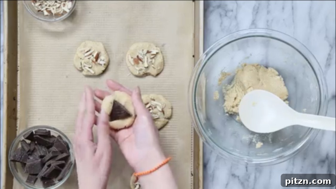 Irresistible Vegan Gluten-Free Almond Coconut Joy Cookies 11 Vegan almond joy cookie dough balls with chocolate chunks on parchment paper before baking