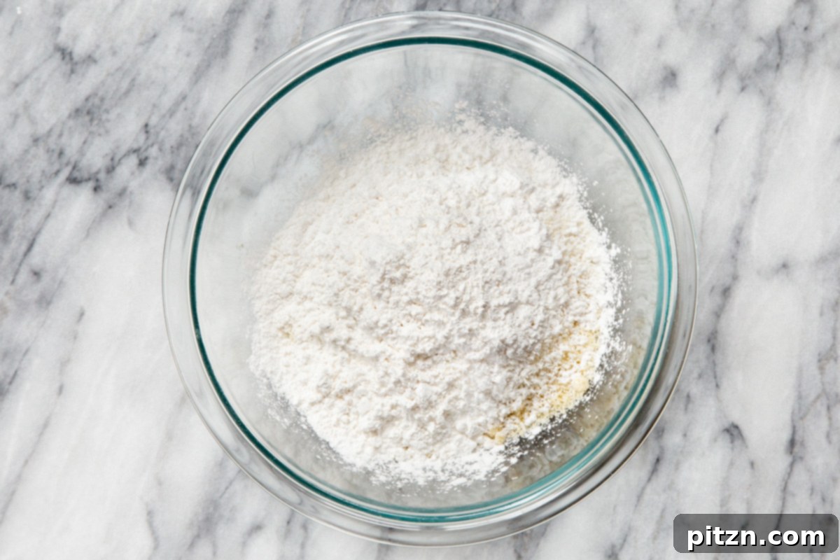 Irresistible Vegan Gluten-Free Almond Coconut Joy Cookies 8 Dry ingredients for vegan Almond Joy cookies in a glass bowl, ready to be mixed