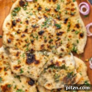 Homemade Spinach Potato Stuffed Naan Bread, perfectly cooked and brushed with garlic butter, ideal as a flavorful side dish.