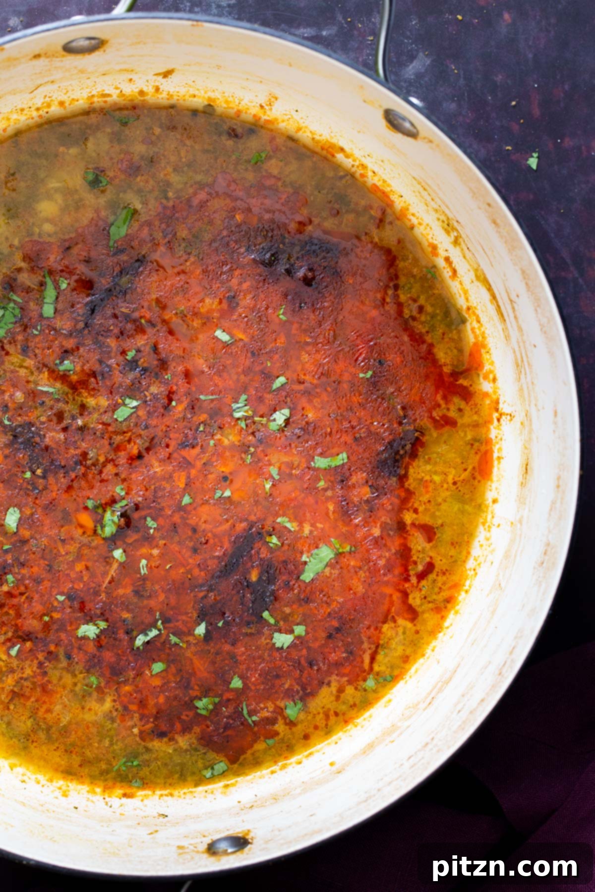 Chataka Dal: Spicy Maharashtrian Toor Dal 13 An inviting overhead shot of a pot filled with richly textured Chataka Dal, featuring the distinct swirl of vibrant tempered spices and fresh green cilantro, ready to be served and enjoyed. This captures the essence of a perfectly made Indian lentil dish.