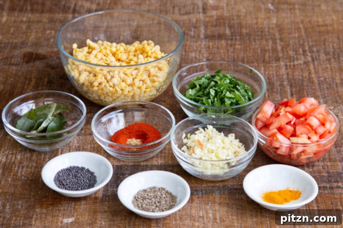 Chataka Dal: Spicy Maharashtrian Toor Dal 6 A vibrant array of fresh ingredients for Chataka Dal, including washed toor dal, chopped tomatoes, fresh cilantro, and various ground spices, neatly laid out on a rustic wooden surface, ready for cooking.