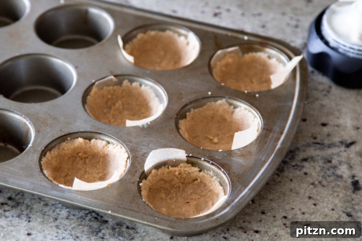 Mini Apple Pie Cheesecake Delights 11 A muffin tin filled with six perfectly pressed vegan pastry crusts, awaiting their filling