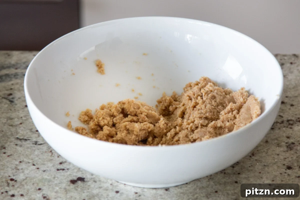 Mini Apple Pie Cheesecake Delights 8 The vegan gluten-free cheesecake crust mixture, a slightly dry but cohesive dough, rests in a bowl after mixing