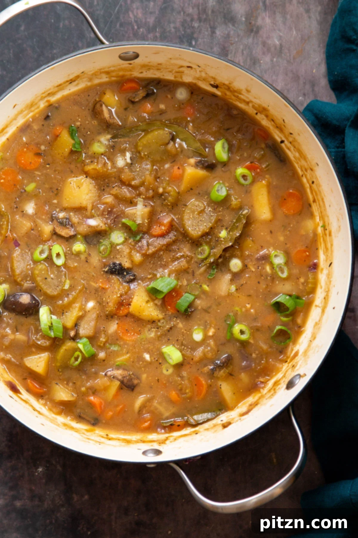 A large pot of rich vegan Irish stew, showcasing its robust vegetables and thick, flavorful broth.