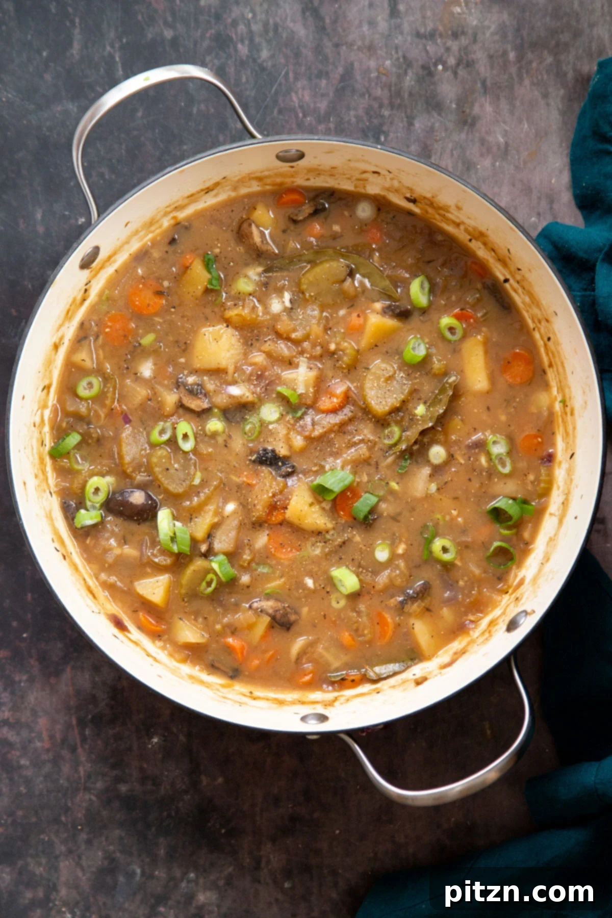 A rustic pot filled to the brim with steaming vegan Irish stew, ready to be served, emphasizing its comforting appeal.