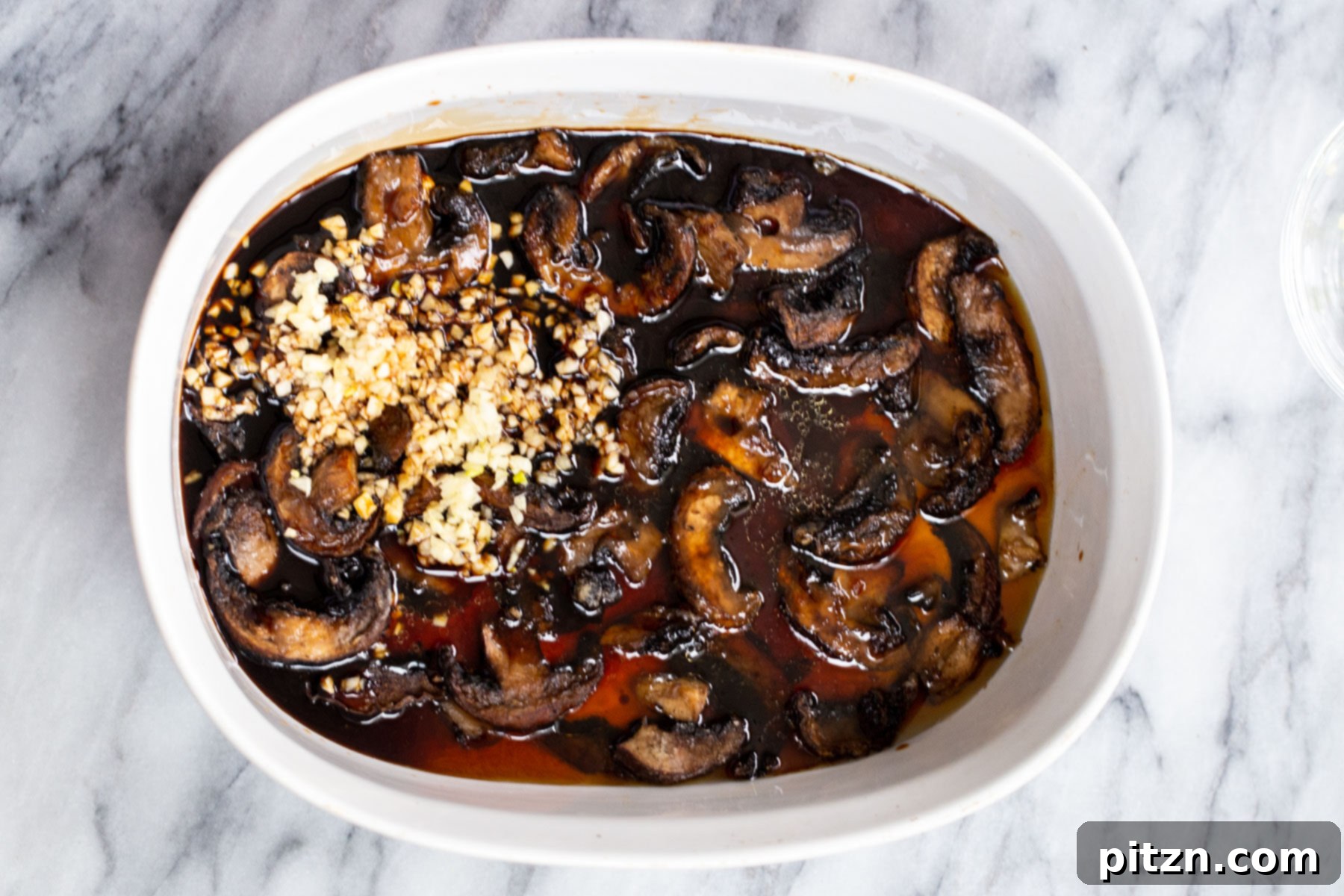 Sesame Glazed Mushrooms 10 Mushroom slices tossed in sweet and salty sauce in a casserole dish