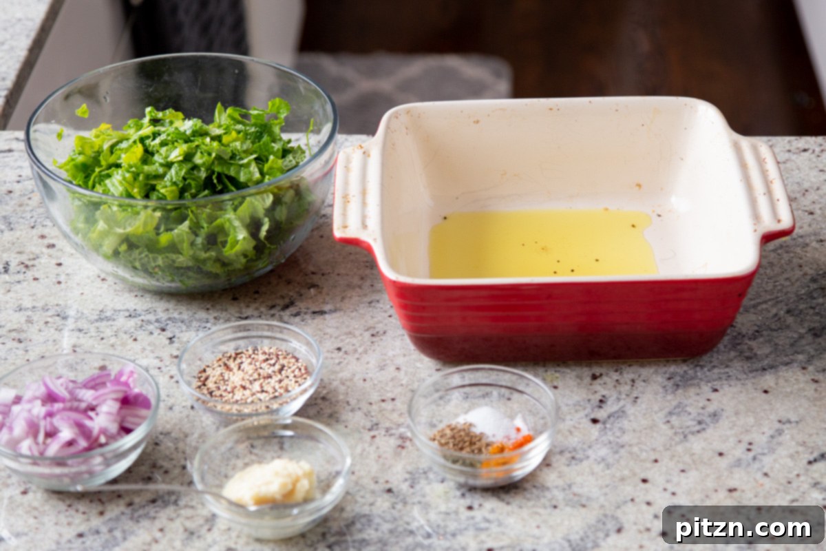A collection of ingredients laid out for making Saag Cornbread Casserole, including various spices, mustard greens, and cornbread components.