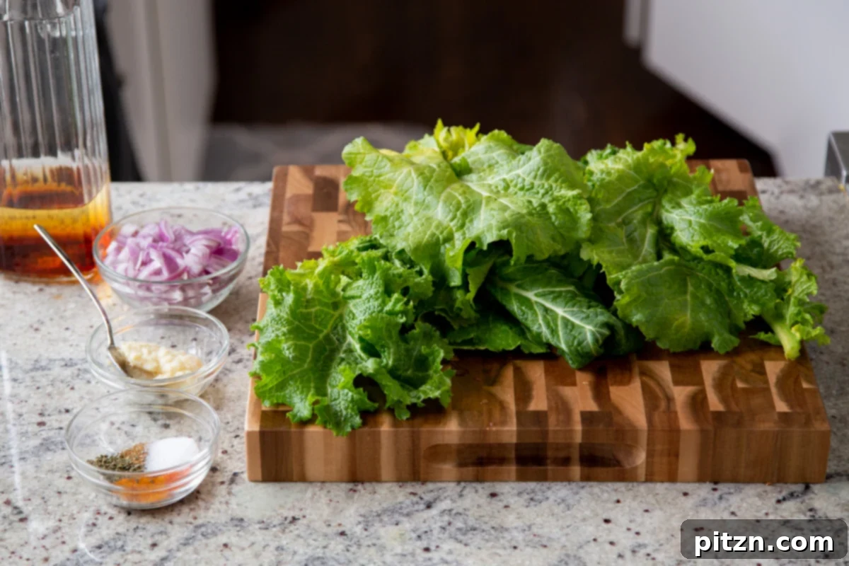 Fresh mustard greens on a wooden chopping board, with an assortment of spices and chopped onions in small dishes to the side, ready for preparation.
