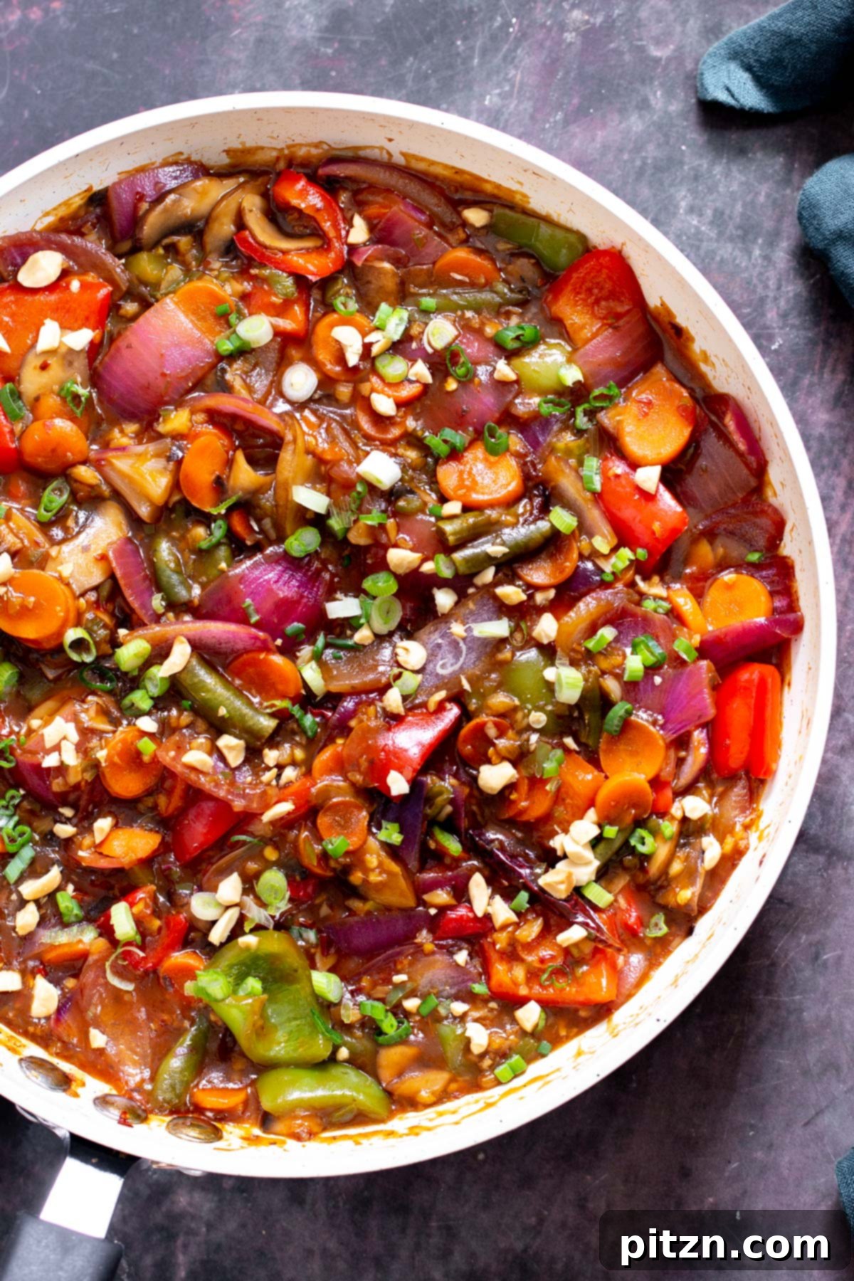 Blazing Garlic Vegetable Medley 14 A large white skillet filled with glistening sweet and sour veggies in hot garlic sauce, beautifully sprinkled with chopped nuts and fresh green onions.