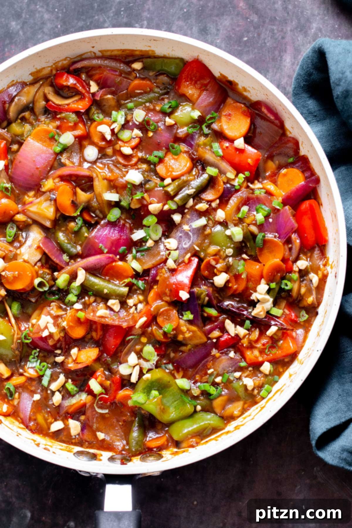 Blazing Garlic Vegetable Medley 3 A close-up view of fresh vegetables simmering in a rich, hot, spicy, and tangy Indo-Chinese sauce in a sauté pan.