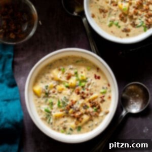 A close-up image of a bowl of vegan Zuppa Toscana with a rich, creamy broth and hearty ingredients.