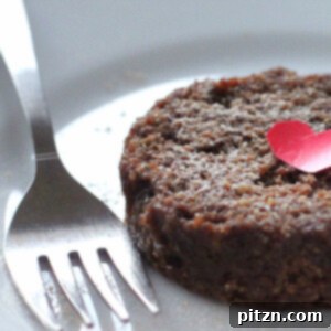 A closeup of a rich chocolate cake on a white plate with a fork, ready to be eaten