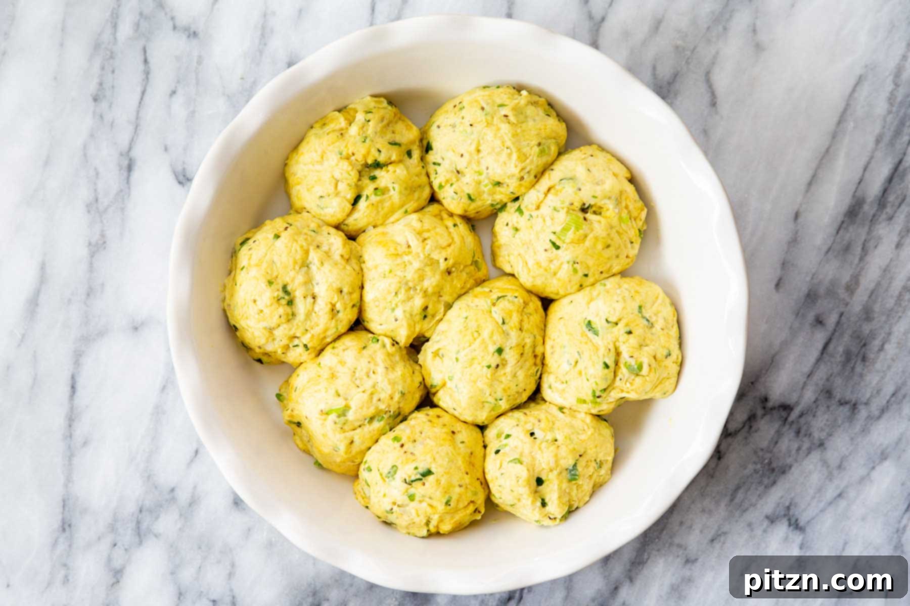 Golden Mustard Coconut Rolls 16 Dough balls neatly arranged in a baking dish, perfectly spaced, before their final rise and baking.