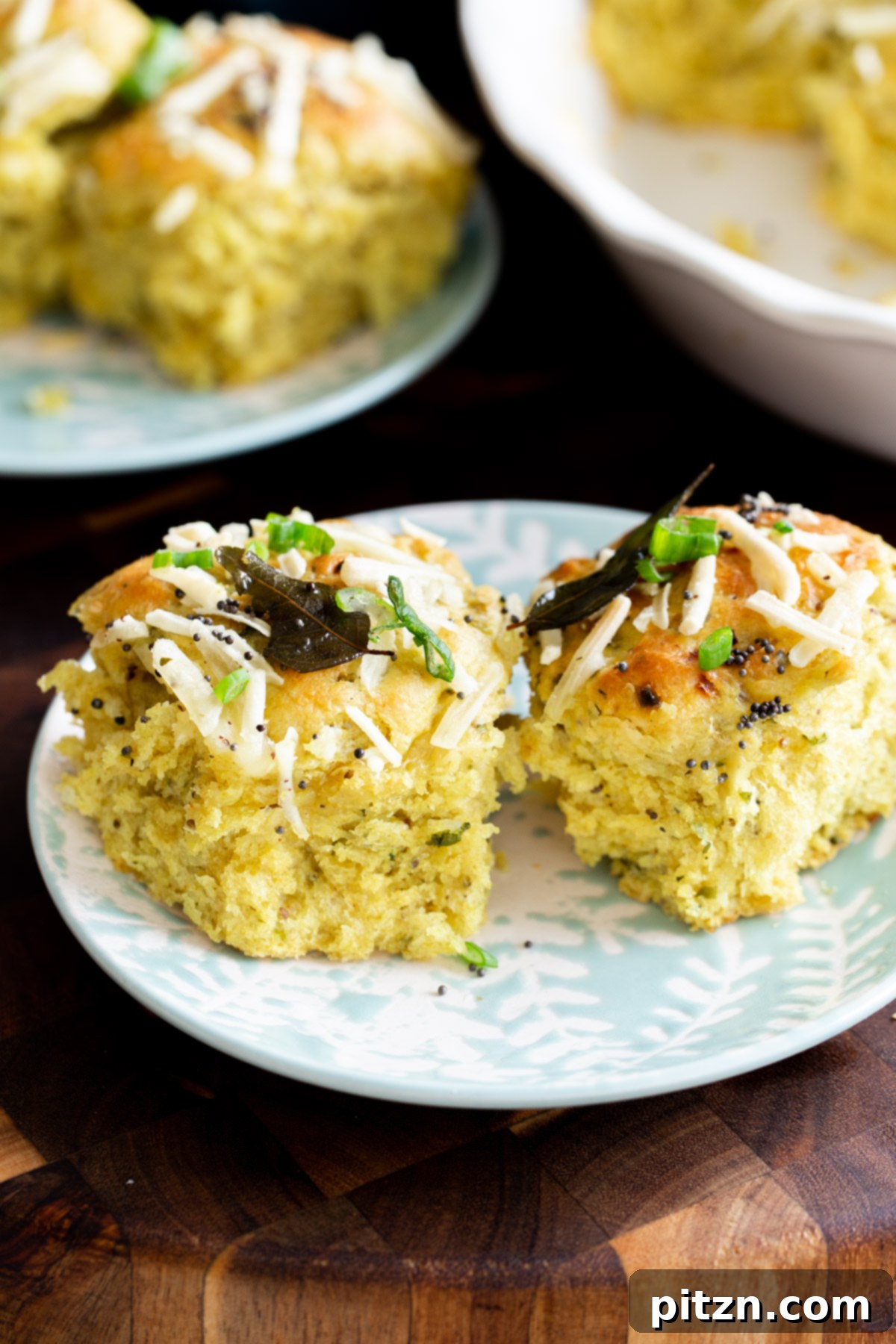Golden Mustard Coconut Rolls 3 A plate of freshly baked, golden brown coconut dinner rolls, showcasing their inviting texture and Indian tempering.