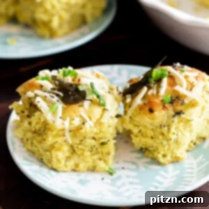 Beautifully plated coconut dinner rolls, gently pulled apart to showcase their delightful texture.