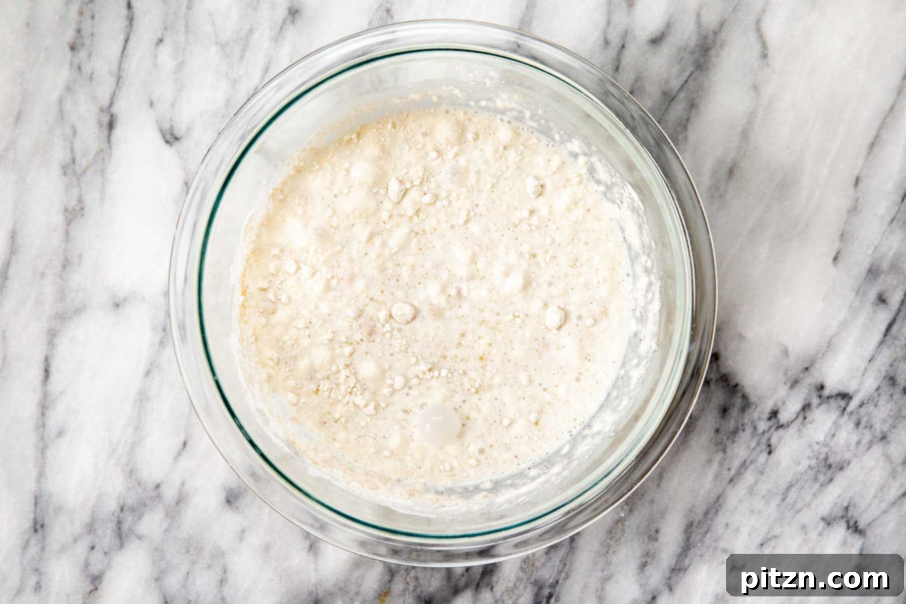 Golden Mustard Coconut Rolls 8 Adding the first cup of flour to the activated yeast mixture, creating a 'sponge'.