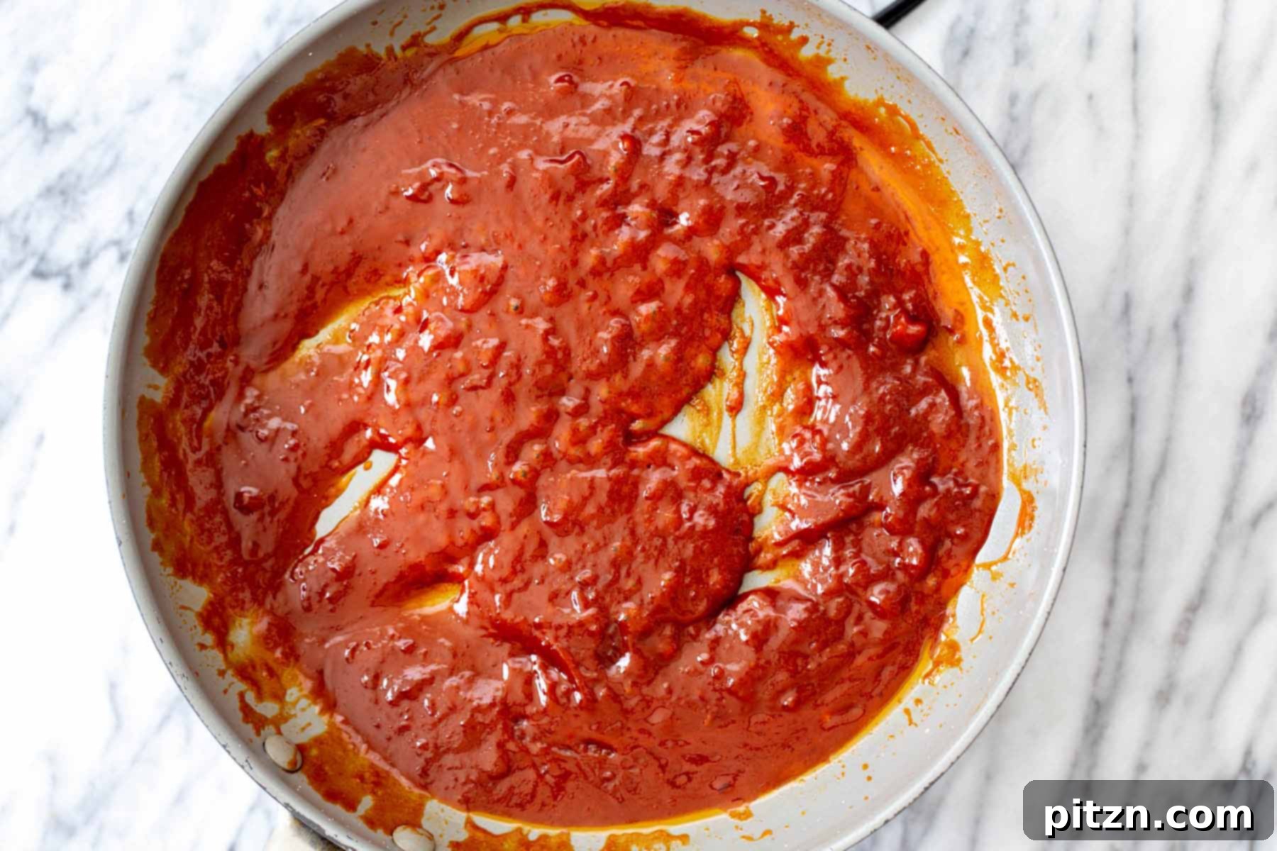 The gochujang sauce in the pan after cooking, showcasing its thickened, glossy texture, ready for the cauliflower.