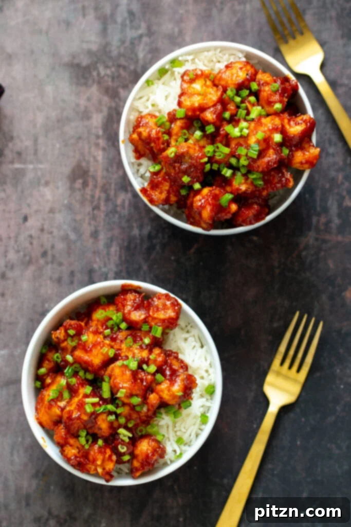 Close-up of baked Gochujang Cauliflower Wings in a bowl, highlighting their glossy sauce coating and crispy edges, ready to be enjoyed as a delicious snack.
