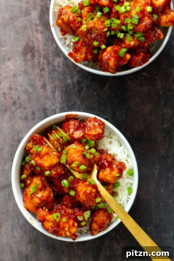 A vibrant platter of Gochujang Cauliflower Wings, garnished with chopped green onions and sesame seeds, illustrating a perfect serving for sharing.