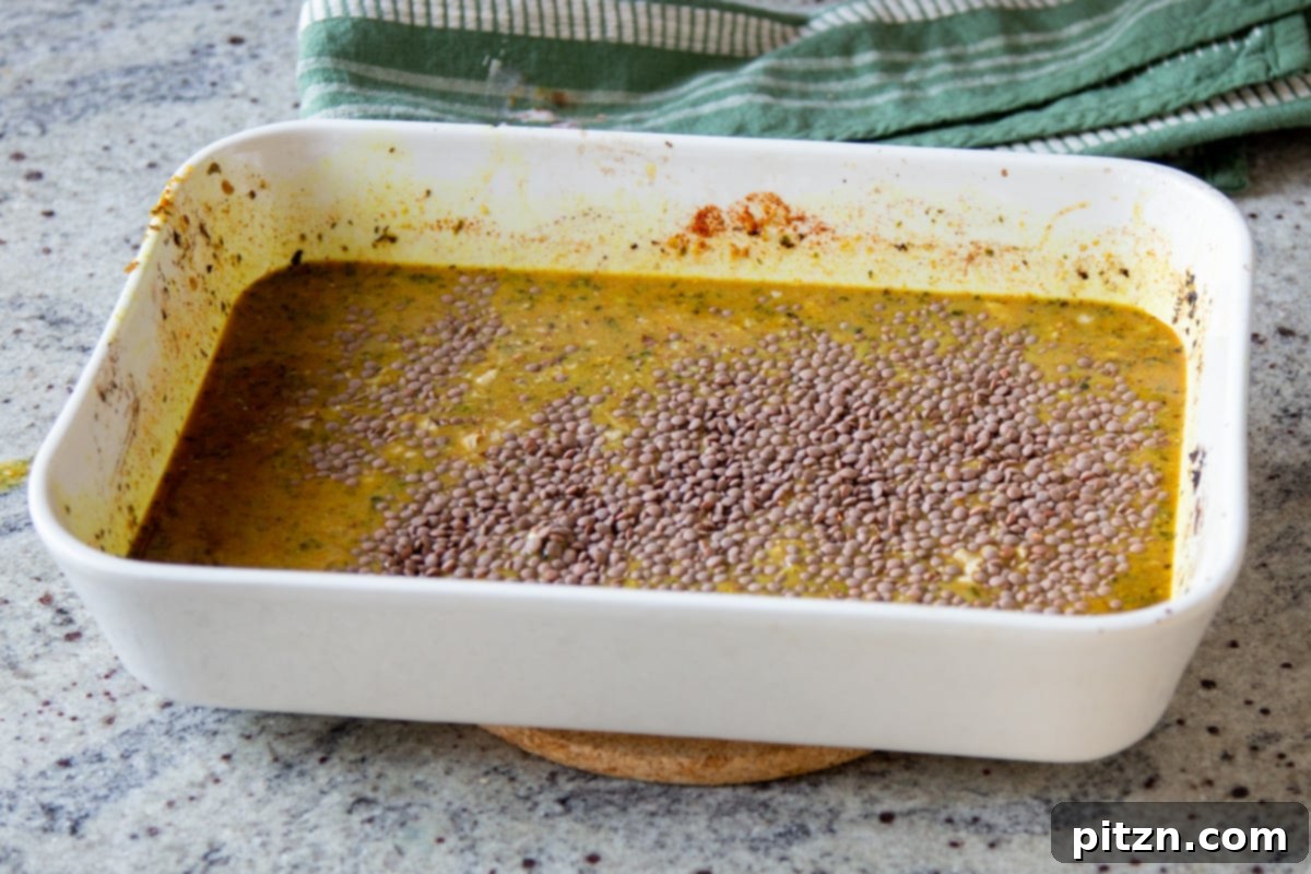 Vegan Lentil Keema Pav Bake 15 lentils added to the baking pan before baking
