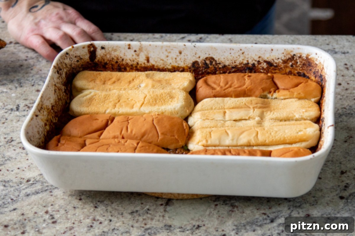 Vegan Lentil Keema Pav Bake 17 hot dog buns placed on top of the lentils in the baking pan