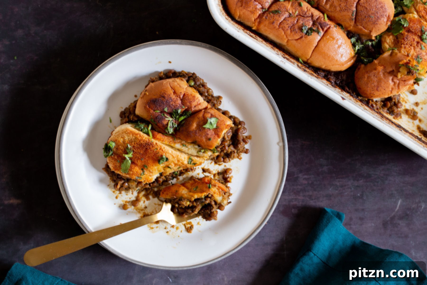 Vegan Lentil Keema Pav Bake 19 Lentil Keema Pav Casserole on the plate with a bite taken out