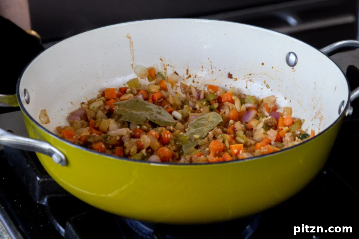 Fireside Smoked Potato Soup 11 Garlic and black pepper mixed into the sautéed vegetables in the pan, now fragrant and slightly cooked