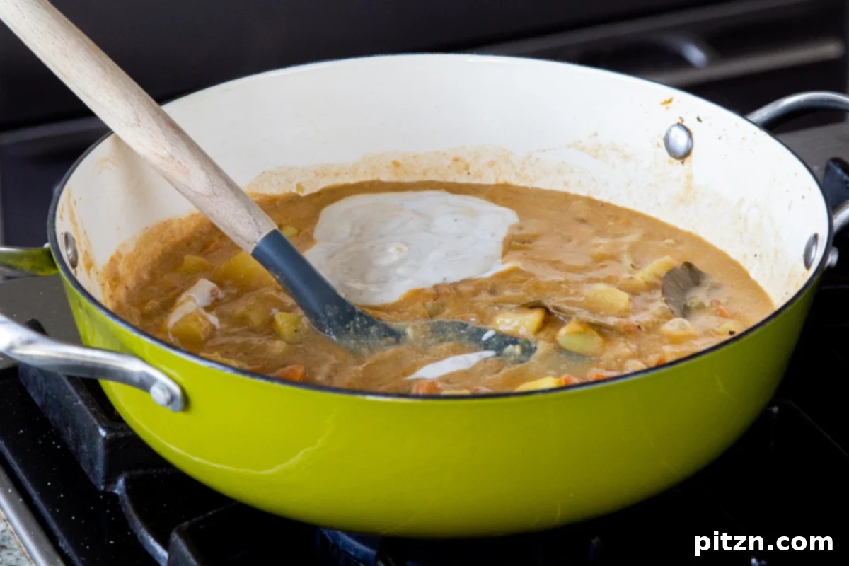 Fireside Smoked Potato Soup 15 Adding vegan yogurt and miso paste to the perfectly cooked potato soup in the pan, just before serving
