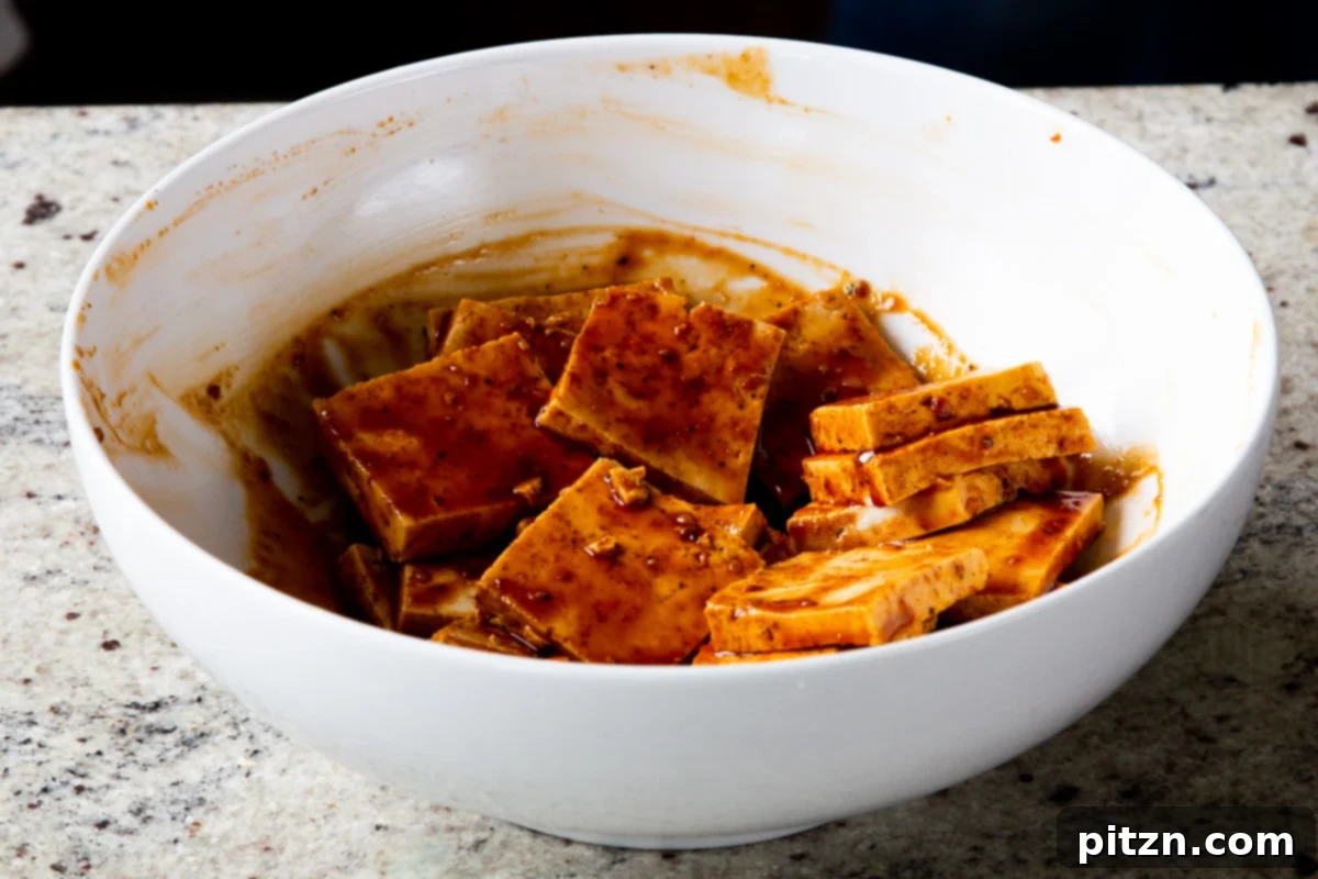 Spicy Gochujang Tofu Sandwich 10 Tofu added to the marinade, after mixing, showing full coating.