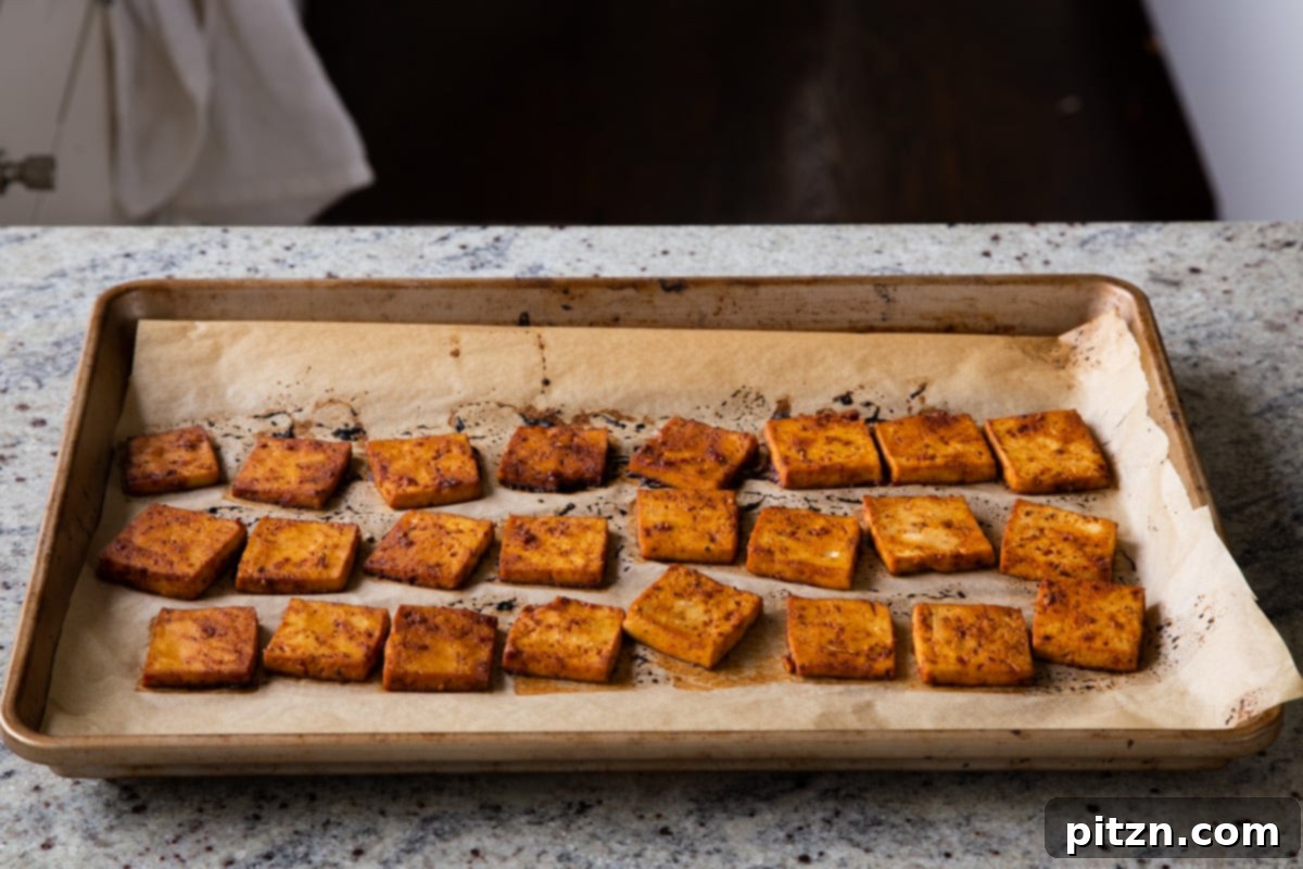 Spicy Gochujang Tofu Sandwich 16 Gochujang tofu on the baking sheet after baking, golden and crispy.