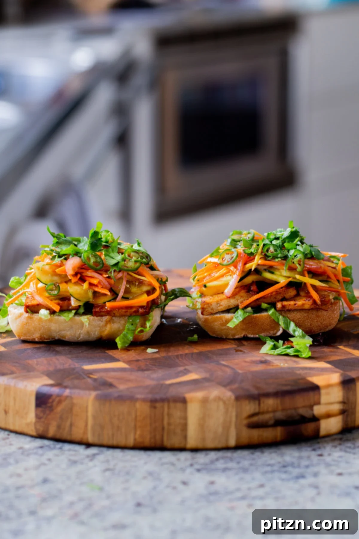 Spicy Gochujang Tofu Sandwich 3 Open-faced gochujang sandwich, revealing layers of gochujang tofu, crisp pickled vegetables, and fresh mango.